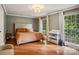 Spacious bedroom with hardwood floors, large windows, and neutral color palette at 1029 Churchill Rd, Davidson, NC 28036