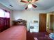 Bedroom with a single bed and a wooden shelving unit at 412 E 18Th St, Charlotte, NC 28206