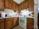 Kitchen with wood cabinets and electric stove at 412 E 18Th St, Charlotte, NC 28206