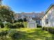 Backyard view of home with storage shed and apartment building in background at 412 E 18Th St, Charlotte, NC 28206