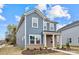 Two-story house with blue siding, brick accents, and landscaping at 502 Amhurst Sw St # 001, Concord, NC 28025