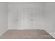 Empty bedroom with double doors and neutral decor at 502 Amhurst Sw St # 001, Concord, NC 28025