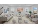 Spacious living room with light gray sofas, ottomans, and a large area rug at 502 Amhurst Sw St # 001, Concord, NC 28025