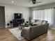 Living room features a sectional sofa, hardwood floors, and large windows at 4050 Fairview Ln, Maiden, NC 28650