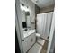 Bathroom with a shower/tub combo, white vanity, and striped shower curtain at 4050 Fairview Ln, Maiden, NC 28650