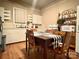 Simple kitchen with white cabinets, wood table and microwave at 84 Walnut Ave, Gastonia, NC 28054