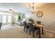 Dining area with wooden table, gray chairs, and chandelier at 6323 Harrisburg Plz, Harrisburg, NC 28075