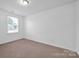 Well-lit bedroom with carpet flooring and a window at 129 Eden Ave, Mooresville, NC 28115