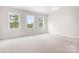 Well-lit bedroom featuring three windows and wall-to-wall carpet at 332 Shinnville Rd, Mooresville, NC 28115