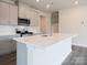 Modern kitchen with gray cabinets, quartz countertops, and an island at 506 Olympia Way, York, SC 29745