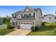 Two-story house with a two-car garage and landscaping at 1814 Mill Creek Ln, Concord, NC 28025