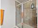 Bathroom with shower, tiled walls, and orange towels at 1814 Mill Creek Ln, Concord, NC 28025