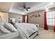 Main bedroom with a large bed, ceiling fan, and red curtains at 1814 Mill Creek Ln, Concord, NC 28025
