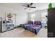 Spacious bedroom with twin beds, playful decor, and a ceiling fan at 1814 Mill Creek Ln, Concord, NC 28025