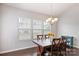Bright dining room with wood table and chairs, featuring large windows at 1814 Mill Creek Ln, Concord, NC 28025
