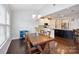 Spacious dining room with a view into the kitchen and wood table at 1814 Mill Creek Ln, Concord, NC 28025