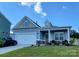 Front view of a charming two-story house with a landscaped yard at 343 Ox Bow Cir, Mount Holly, NC 28120