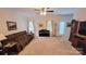 Living room with brown reclining sofa, piano, and large windows at 343 Ox Bow Cir, Mount Holly, NC 28120