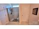 Clean bathroom with a shower, built-in seat, and tiled walls at 343 Ox Bow Cir, Mount Holly, NC 28120