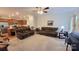 Open living room with brown reclining sofas and a view of the kitchen at 343 Ox Bow Cir, Mount Holly, NC 28120