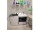 Functional laundry room with a washer, dryer, and shelving at 343 Ox Bow Cir, Mount Holly, NC 28120