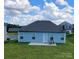 Back of house showing patio and grassy backyard at 343 Ox Bow Cir, Mount Holly, NC 28120