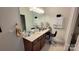 Elegant bathroom vanity with modern fixtures and a large mirror at 343 Ox Bow Cir, Mount Holly, NC 28120