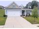 Two-story house with light blue siding, a white garage door, and landscaping at 343 Ox Bow Cir, Mount Holly, NC 28120