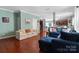 Living room with hardwood floors, off-white sofa, and blue sectional at 5051 Meanna Dr, Clover, SC 29710