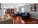 Spacious living room with hardwood floors, sectional sofa, and kitchen view at 5051 Meanna Dr, Clover, SC 29710