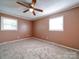 Bright bedroom featuring neutral walls, carpeting, and two windows at 624 Newcastle Rd, Gastonia, NC 28052