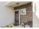 Front door entrance with stone accent wall and a welcoming porch at 1097 Sw River Haven Ave, Concord, NC 28025