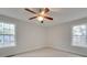Well-lit bedroom featuring two windows and ceiling fan at 1205 Danielle Downs Ct, Concord, NC 28025