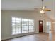 Living room with vaulted ceiling, hardwood floors, and a large window at 1205 Danielle Downs Ct, Concord, NC 28025