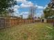 Fenced backyard with storage shed and grassy area at 1205 Danielle Downs Ct, Concord, NC 28025