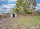 Fenced backyard with storage shed and grassy area at 1205 Danielle Downs Ct, Concord, NC 28025