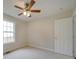 Spacious bedroom featuring a ceiling fan, window, and neutral walls at 1205 Danielle Downs Ct, Concord, NC 28025