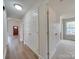 Clean hallway with wood floors and multiple doors at 1205 Danielle Downs Ct, Concord, NC 28025