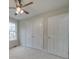 Bright bedroom with ceiling fan, carpet, and double doors at 1205 Danielle Downs Ct, Concord, NC 28025