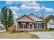 Brick ranch home with landscaping and a paved driveway at 1205 Danielle Downs Ct, Concord, NC 28025