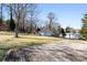 Backyard with wooden deck, outbuildings, and trees at 1705 Enochville Rd, Kannapolis, NC 28081