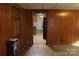 Simple living room with wood paneling and access to the kitchen at 2020 Parkdale Ave, Gastonia, NC 28052