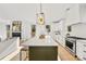 Modern kitchen with white cabinets, green island, and stainless steel appliances at 3623 Avalon Ave, Charlotte, NC 28208