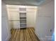 Walk-in closet with built-in shelving and hanging rods at 409 19Th Ave Nw Cir # 12, Hickory, NC 28601