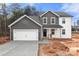 Two-story home with gray and white siding, a two-car garage, and a concrete driveway at 4126 Old Monroe Marshville Rd, Wingate, NC 28174