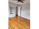 Hardwood floor bedroom with ceiling fan and mirrored walls at 910 Mcalway Rd # C, Charlotte, NC 28211