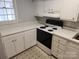 White kitchen with ample cabinetry and an electric range at 910 Mcalway Rd # C, Charlotte, NC 28211