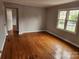 Hardwood floor living room with an open doorway and large windows at 910 Mcalway Rd # C, Charlotte, NC 28211