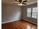 Spacious bedroom with hardwood floors, large windows, and ceiling fan at 910 Mcalway Rd # C, Charlotte, NC 28211