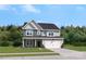 Two-story house with stone and siding accents, attached garage, and landscaping at 303 Coronado Ave # 60, Matthews, NC 28104